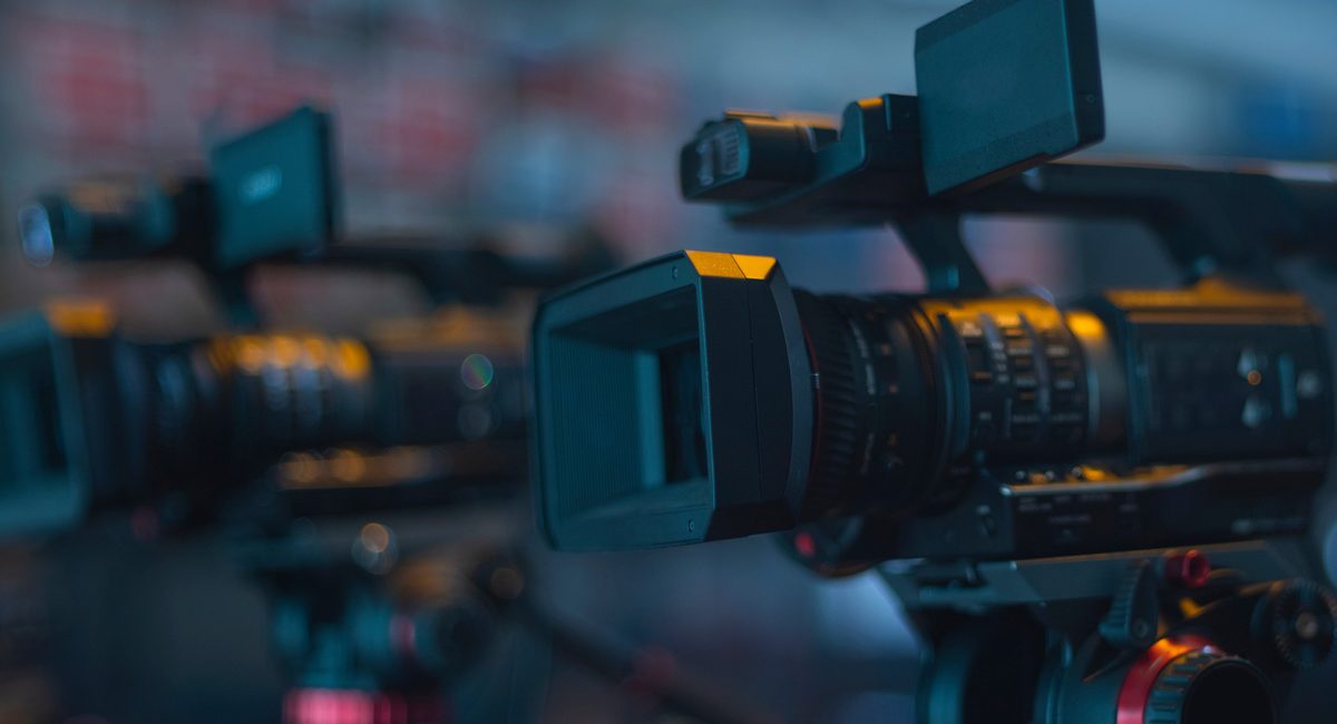 Three attractive sport girls smiling while doing abs lying on yoga mat in fitness class